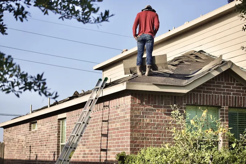 Professional roofer working on a residential roof in Hickory Tree